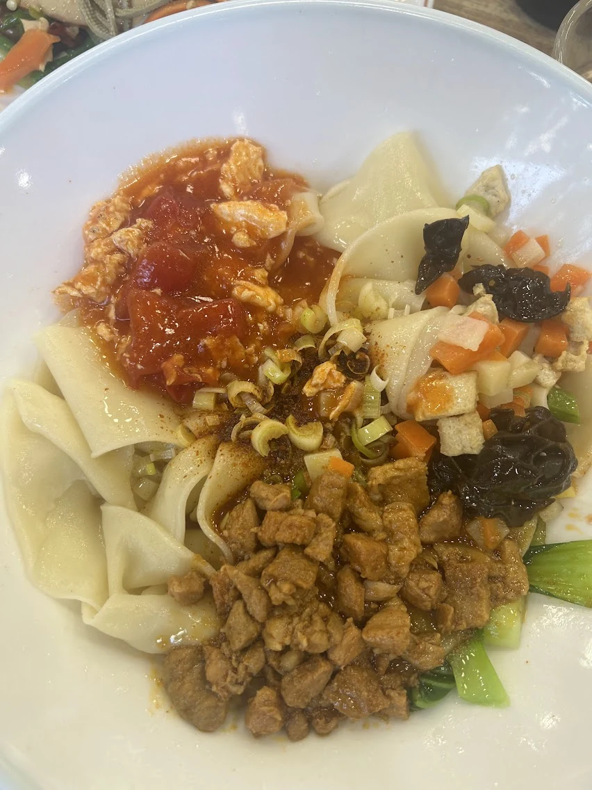 A bowl of Shanxi noodles with a variety of toppings